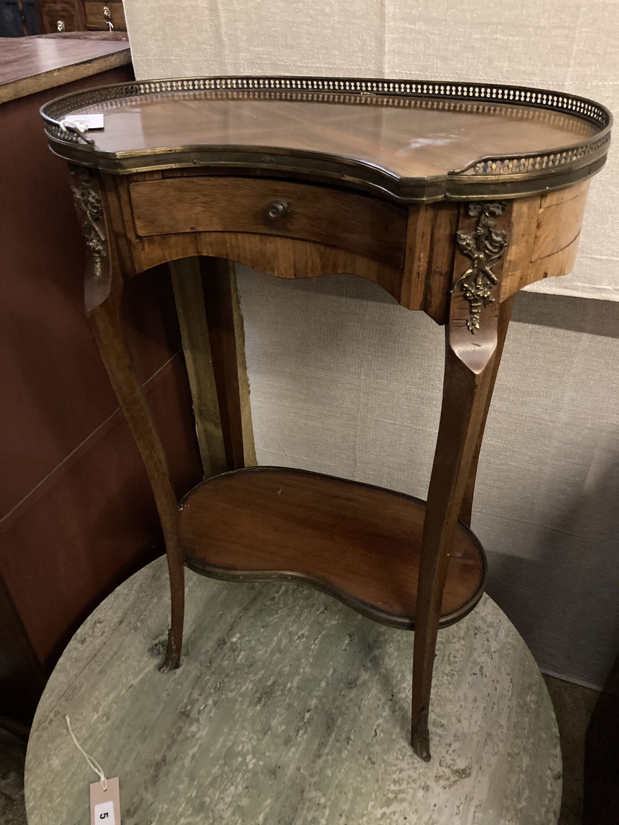 A Louis XVI style kidney top side table, with gilt brass gallery over a single drawer and upper tier, on slender cabriole supports, wid